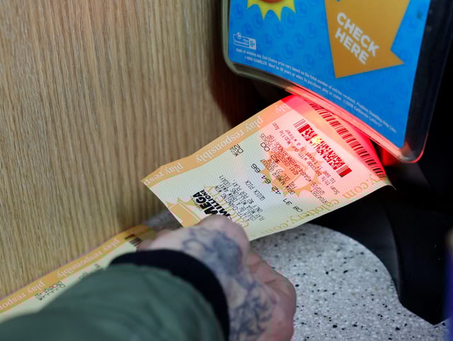 A customer scans a Mega Millions ticket to see if it is a winner at Circle K where the latest winning Mega Millions jackpot lottery ticket was sold, in Cottonwood, California, U.S. December 28, 2024.