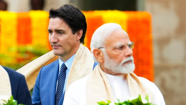 Canada's Prime Minister Justin Trudeau, left, walks past India's Prime Minister Narendra Modi as they take part in a wreath-laying ceremony at Raj Ghat, Mahatma Gandhi's cremation site, during the G20 Summit in New Delhi. (AP File)