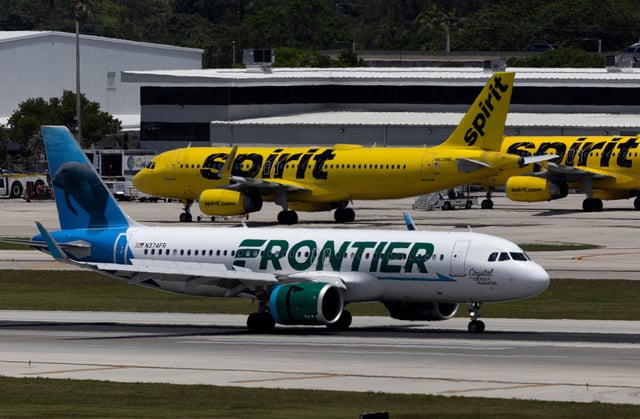 A Frontier Airlines plane near a Spirit Airlines plane at the Fort Lauderdale-Hollywood International Airport.