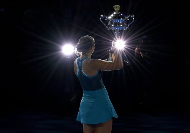 Madison Keys of the United States lifts the Daphne Akhurst Memorial Cup after the Women's Singles Trophy Presentation following the Women's Singles Final against Aryna Sabalenka during day 14 of the 2025 Australian Open at Melbourne Park on January 25, 2025 in Melbourne, Australia.