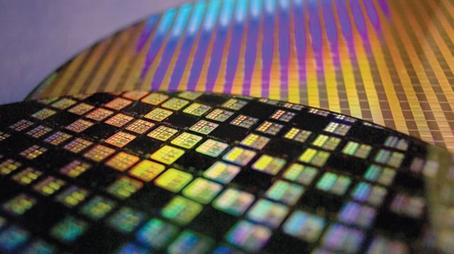 TSMC chips shown on a wafer. Proposed tariffs on imported chips might force Apple to raise prices on some products.