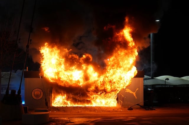 A fire at a nearby merchandise kiosk outside the stadium before during the UEFA Champions League match (Photo: Martin Rickett/PA Wire)