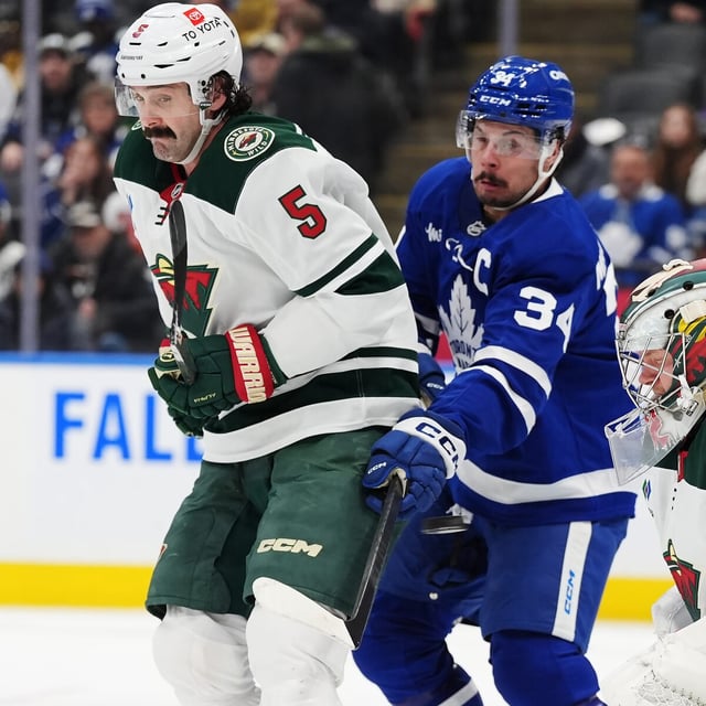 Toronto Maple Leafs' Auston Matthews (34) tries to tip the puck in front of Minnesota Wild goaltender Filip Gustavsson (32) as Jake Middleton (5) defends during second period NHL hockey action in Toronto on Wednesday, January 29, 2025. THE CANADIAN PRESS/Frank Gunn