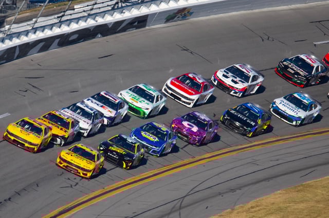 Joey Logano (22) and Michael McDowell (38) lead the field during the 2024 Daytona 500 at Daytona International Speedway.