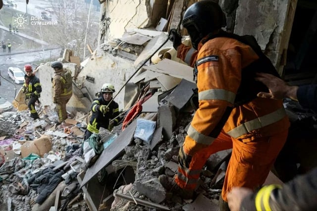 Ukrainian rescuers cleaning rubble of a  residential building following the overnight drone attack