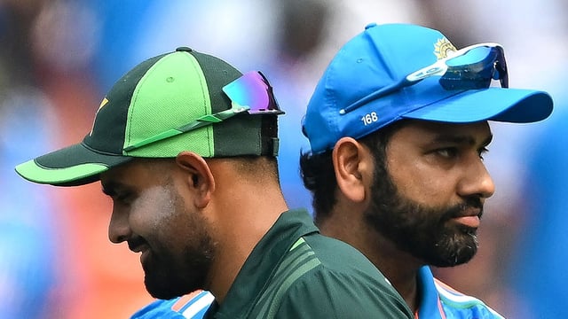 (FILES) India's captain Rohit Sharma (R) and his Pakistani counterpart Babar Azam