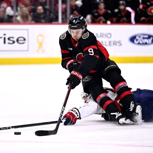 Ottawa Senators' Josh Norris (9) gets tripped by Washington Capitals' John Carlson (74), leading to Norris' penalty shot goal, during second period NHL hockey action in Ottawa, on Thursday, Jan. 30, 2025. THE CANADIAN PRESS/Justin Tang