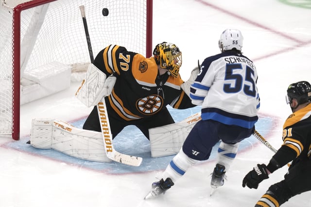 Winnipeg Jets center Mark Scheifele (55) shoots the puck past Boston Bruins goaltender Joonas Korpisalo (70) for a goal during the third period of an NHL hockey game, Thursday, Jan. 30, 2025, in Boston. (AP Photo/Charles Krupa)