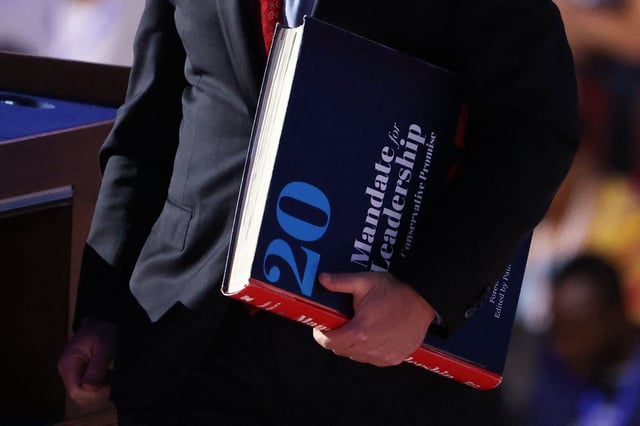 Colorado Governor Jared Polis holds a "Project 2025" book on Day 3 of the Democratic National Convention (DNC) in Chicago, Illinois, U.S., August 21, 2024. REUTERS/Brendan Mcdermid