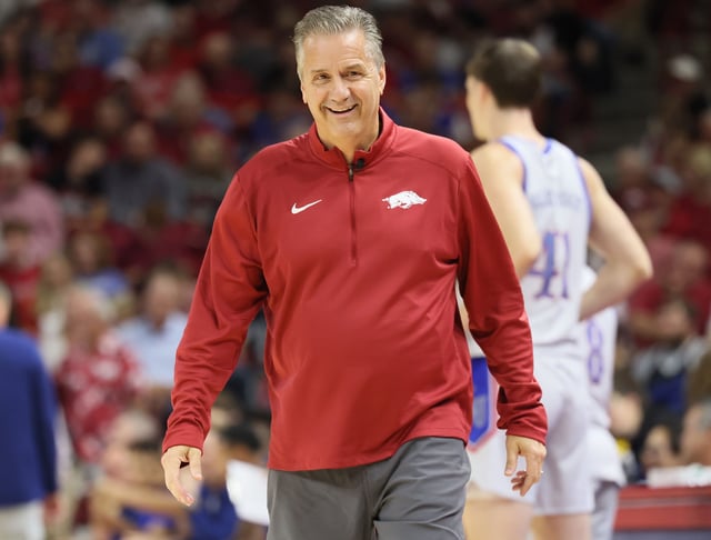 Arkansas men's basketball coach John Calipari smiles during a preseason scrimmage against Kansas at Bud Walton Arena.