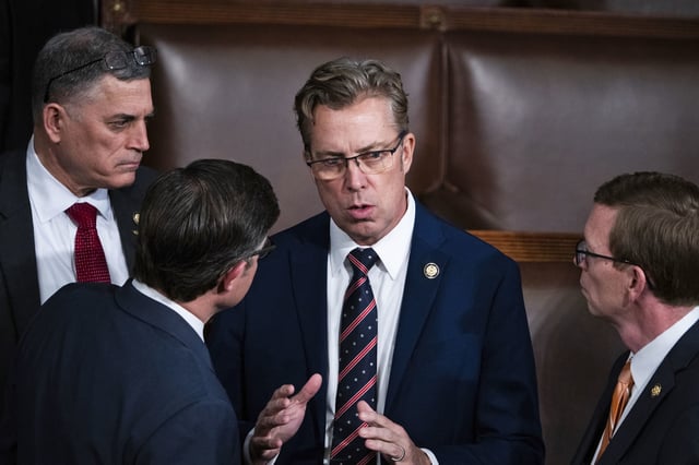 Rep. Andy Ogles, R-Tenn., center, talks with other representatives in the House chamber on Jan. 3, 2025. 