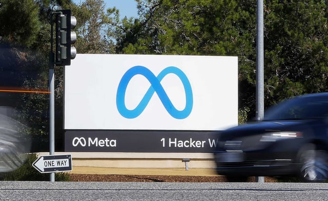 A car passes Facebook&#39;s new Meta logo on a sign at the company headquarters on Oct. 28, 2021, in Menlo Park, Calif.