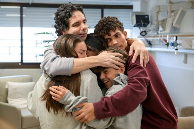 Ofer Kalderon embraced his children at Sheba Hospital near Tel Aviv on Saturday.