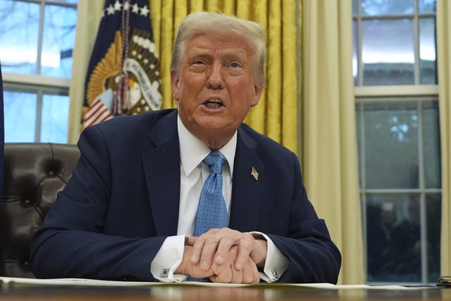 President Donald Trump speaks to reporters as he signs executive orders in the Oval Office of the White House, Friday, January 31, 2025, in Washington.