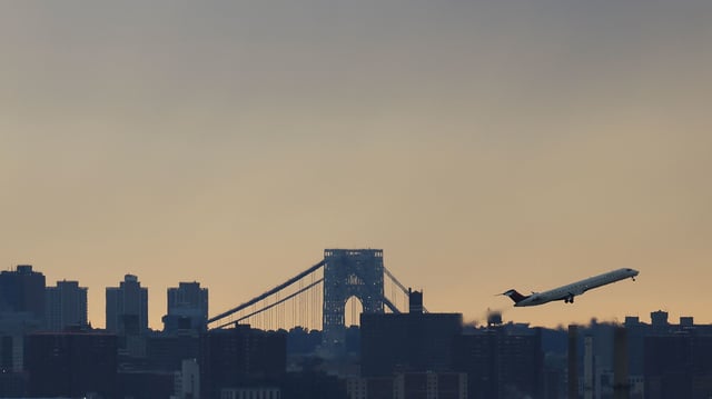 A plane flies over New York on June 14, 2024.