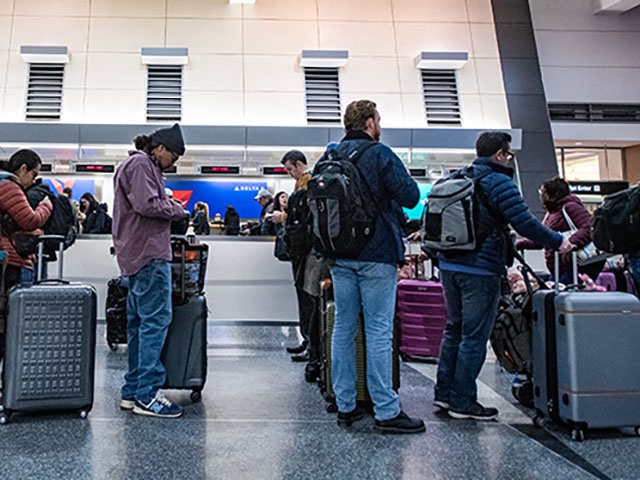 People wait in line to check their luggage at Terminal A at Boston's Logan Airport on December 23, 2024, ahead of the upcoming Christmas holiday. AAA reports that an estimated 7.85 million passengers will take to the air this holiday season. (Photo by Joseph Prezioso / AFP) (Photo by JOSEPH PREZIOSO/AFP via Getty Images)