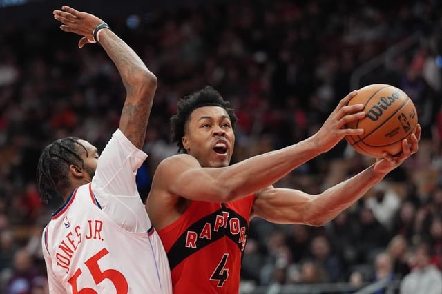 Toronto Raptors forward Scottie Barnes (4) moves to the basket as Los Angeles Clippers forward Derrick Jones Jr. (55) defends during second half NBA action in Toronto on Sunday, Feb. 2, 2025. THE CANADIAN PRESS/Frank Gunn