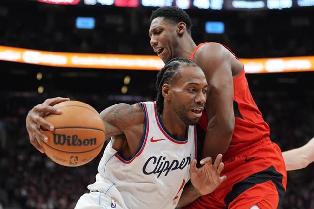Los Angeles Clippers forward Kawhi Leonard (2) tries to get around Toronto Raptors guard RJ Barrett (9) during first half NBA action in Toronto on Sunday, Feb. 2, 2025. THE CANADIAN PRESS/Frank Gunn