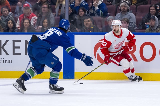 Feb 2, 2025; Vancouver, British Columbia, CAN; Detroit Red Wings forward Alex DeBrincat (93) drives on Vancouver Canucks forward Conor Garland (8) in overtime at Rogers Arena. Mandatory Credit: Bob Frid-Imagn Images