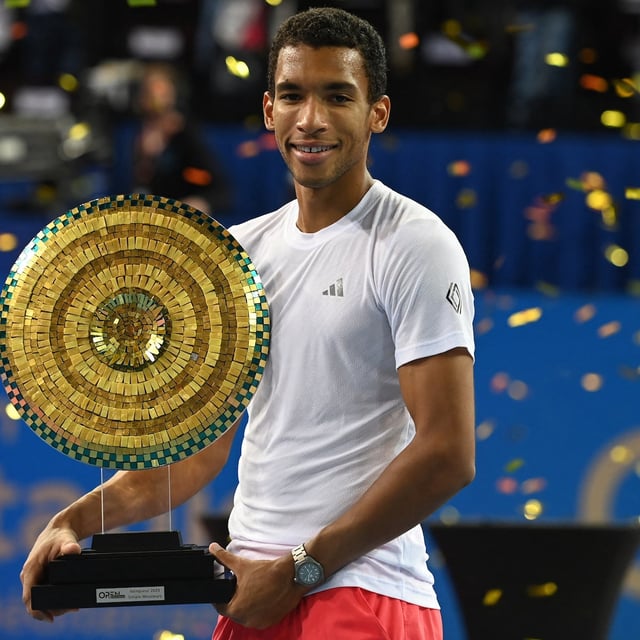 Canada's Felix Auger Aliassime poses for pictures holding the trophy after winning the ATP World Tour Open Occitanie final tennis match against US's Aleksandar Kovacevic, in Montpellier, southern France on February 2, 2025. (Photo by Sylvain THOMAS / AFP) (Photo by SYLVAIN THOMAS/AFP via Getty Images)