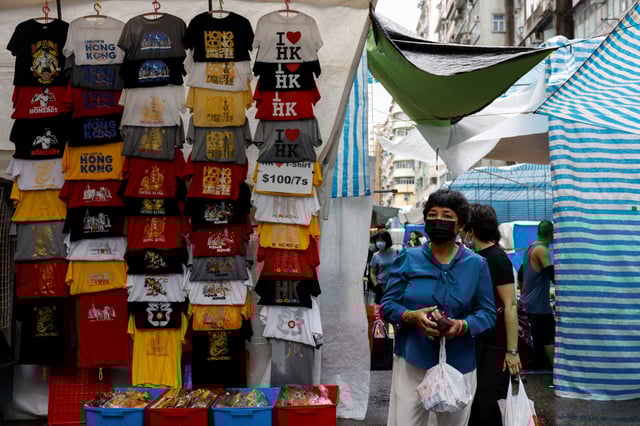 People walk at the Ladies' Market, a popular tourist attraction, in Mongkok, Hong Kong, China April 23, 2024. REUTERS/Tyrone Siu/File Photo