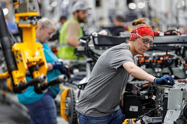 An employee works on an assembly line at startup Rivian Automotive's electric vehicle factory in Normal, Illinois, U.S. April 11, 2022.  REUTERS/Kamil Krzaczynski/File Photo