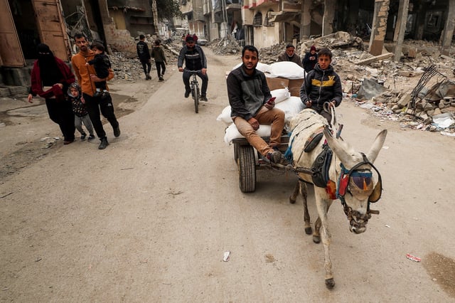 Palestinians transport aid supplies on an animal-drawn cart, amid a ceasefire between Hamas and Israel, in Gaza City, February 3, 2025. REUTERS/Dawoud Abu Alkas