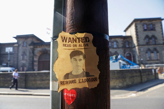 A wanted sign featuring an image of Daniel Abed Khalife, a former soldier who is suspected of terrorism offences, is displayed, near Wandsworth prison which he escaped from, in London, Britain, September 7, 2023. REUTERS/Anna Gordon/File Photo