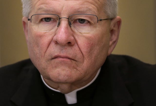FILE - Archbishop Gregory Aymond, of New Orleans, listens to a question at a news conference at the United States Conference of Catholic Bishops' annual fall meeting in Baltimore, Tuesday, Nov. 12, 2013. (AP Photo/Patrick Semansky, File)