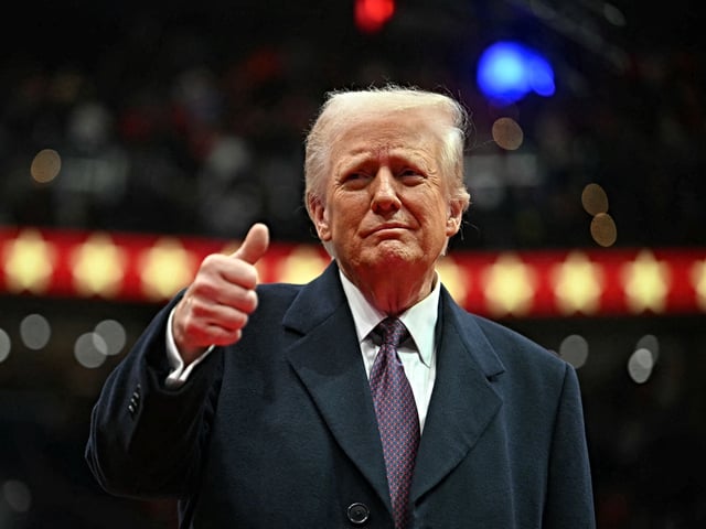 US President Donald Trump give the thumbs up during the inaugural parade inside Capitol One Arena in Washington, DC, on January 20, 2025. (Photo by Jim WATSON / AFP)