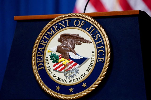 The seal of the U.S. Justice Department is seen on the podium in the Department's headquarters briefing room before a news conference with the Attorney General in Washington, January 24, 2023. REUTERS/Kevin Lamarque/File Photo