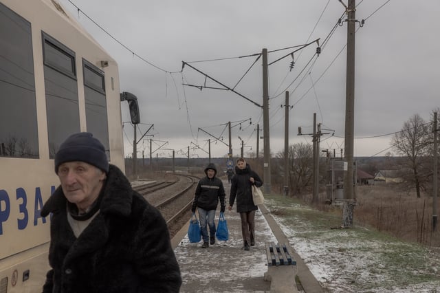 Passengers walk to board a train in the village of Osynovo in Ukraine&#39;s Kharkiv region on December 9, 2024.