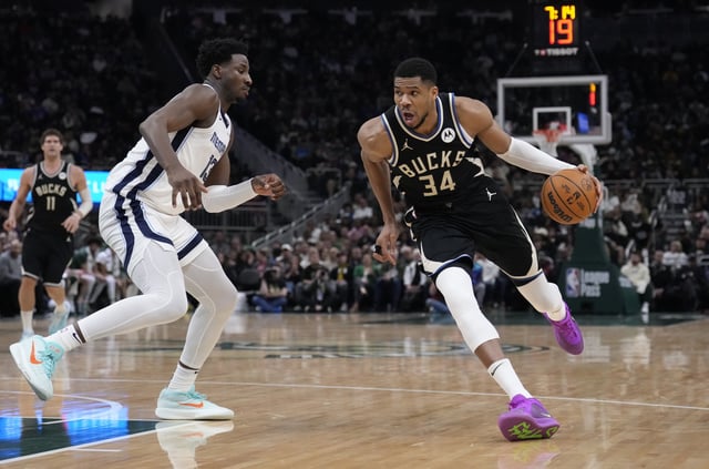 Feb 2, 2025; Milwaukee, Wisconsin, USA; Milwaukee Bucks forward Giannis Antetokounmpo (34) drives to the basket against Memphis Grizzlies forward Jaren Jackson Jr. (13) in the first half at Fiserv Forum. Mandatory Credit: Michael McLoone-Imagn Images