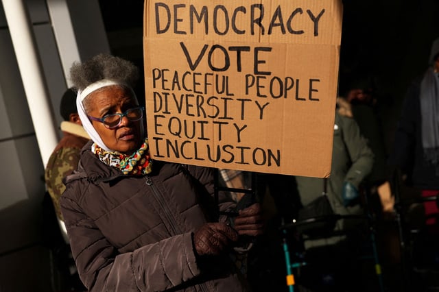 People protesting billionaire Bill Ackman's campaign against diversity, equity, and inclusion are pictured in New York City on January 4.