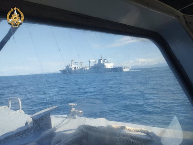This image released by the Philippine military on February 4 shows the U.S. ally monitoring a Type 903 Fuchi-class replenishment oiler, one of three Chinese warships that sailed through the Mindoro Strait and into the Sulu Sea.