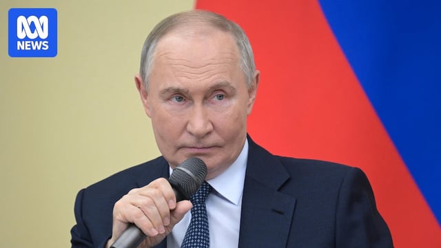Vladimir Putin holding a microphone