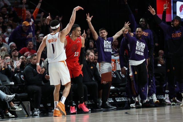 Phoenix Suns guard Devin Booker reacts after scoring against the Portland Trail Blazers to make Booker the Suns’ all-time leading scorer.