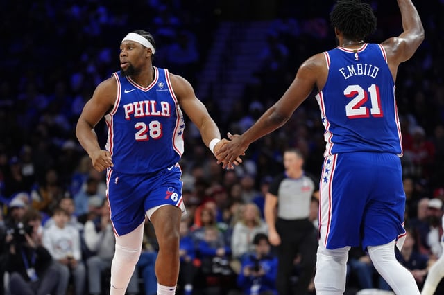 Guerschon Yabusele and Joel Embiid high fiving.