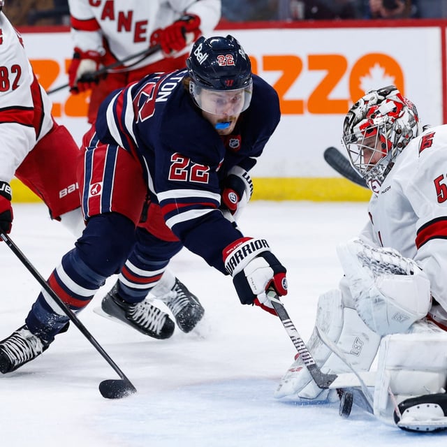 Feb 4, 2025; Winnipeg, Manitoba, CAN;  Carolina Hurricanes goalie Pyotr Kocketkov (52) makes a save on Winnipeg Jets forward Mason Appleton (22) during the second period at Canada Life Centre. Mandatory Credit: Terrence Lee-Imagn Images