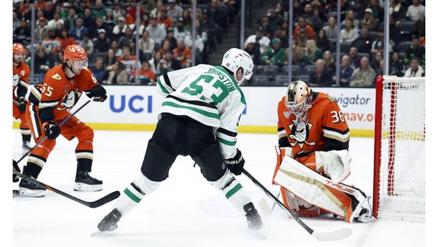 Ducks goaltender John Gibson, right, makes a save against the Dallas Stars’ Wyatt Johnston, center, during the first period on Tuesday night at Honda Center. Playing in his 500th career NHL game, Gibson made 26 saves in a 2-1 win. (Photo by Ronald Martinez/Getty Images)