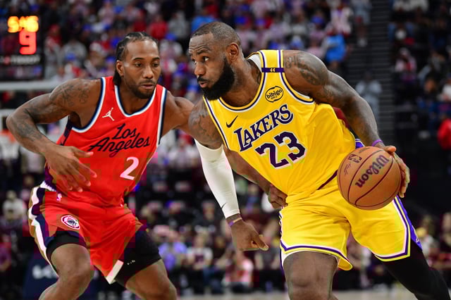 Feb 4, 2025; Inglewood, California, USA; Los Angeles Lakers forward LeBron James (23) moves the ball against Los Angeles Clippers forward Kawhi Leonard (2) during the second half at Intuit Dome. Mandatory Credit: Gary A. Vasquez-Imagn Images