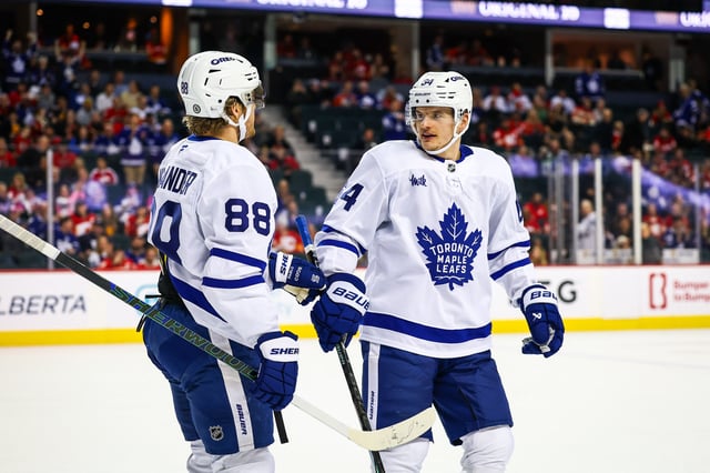 Feb 4, 2025; Calgary, Alberta, CAN; Toronto Maple Leafs right wing William Nylander (88) celebrates his goal with teammates against the Calgary Flames during the third period at Scotiabank Saddledome. Mandatory Credit: Sergei Belski-Imagn Images