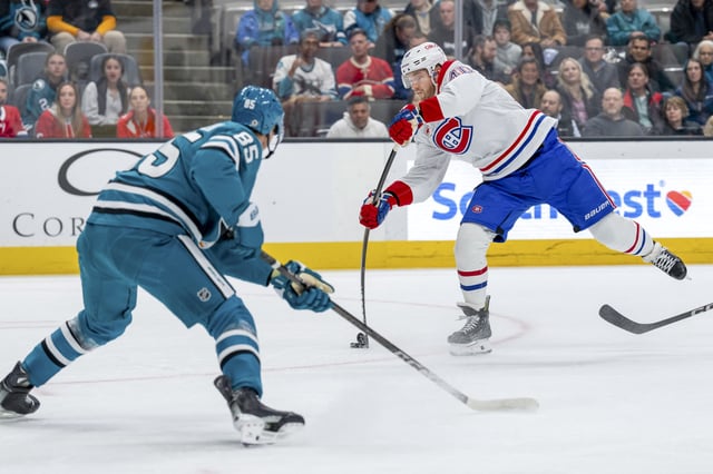 Feb 4, 2025; San Jose, California, USA;  Montreal Canadiens right wing Joel Armia (40) takes a shot on gold in front of San Jose Sharks defenseman Shakir Mukhamadullin (85) during the first period at SAP Center at San Jose. Mandatory Credit: Neville E. Guard-Imagn Images