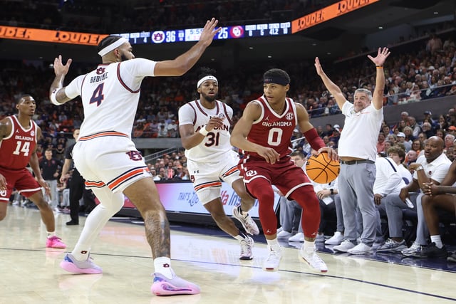 Feb 4, 2025; Auburn, Alabama, USA; Auburn Tigers forward Johni Broome (4) pressures Oklahoma Sooners guard Jeremiah Fears (0) during the first half at Neville Arena. Mandatory Credit: John Reed-Imagn Images
