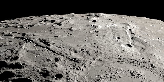 View of two grand canyons on the Moon radiating from the Schrödinger impact basin near the lunar south pole on the lunar far side.  View is from orbit looking obliquely across the surface, like an astronaut in an approaching spacecraft. 