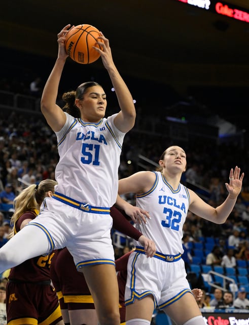 UCLA center Lauren Betts (51) grabs a rebound over Minnesota forward Mallory Heyer (24) and UCLA forward Angela Dugalic (32) during their game on Feb. 2, 2025.