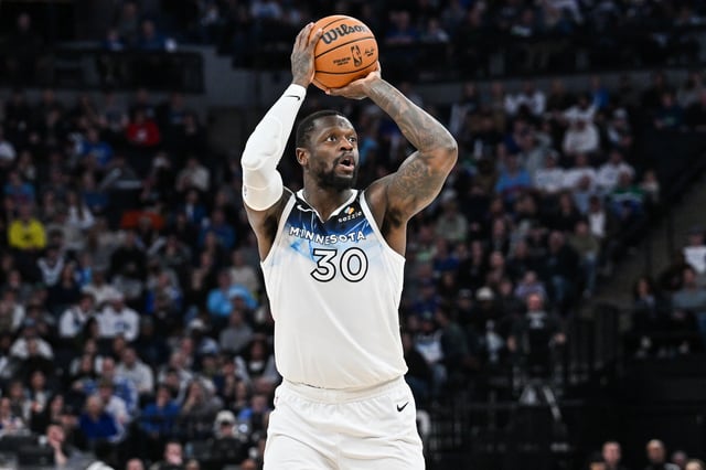 Jan 25, 2025; Minneapolis, Minnesota, USA; Minnesota Timberwolves forward Julius Randle (30) shoots a three point basket against the Denver Nuggets during the fourth quarter at Target Center. Mandatory Credit: Jeffrey Becker-Imagn Images/File Photo