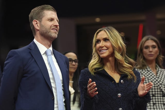 Eric and Lara Trump talks as President Donald Trump attends an indoor Presidential Inauguration parade event at Capital One Arena, Monday, Jan. 20, 2025, in Washington. (AP Photo/Evan Vucci)