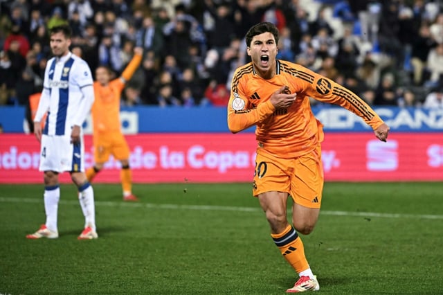 Real Madrid's Spanish forward Gonzalo Garcia (R) celebrates scoring their third goal against Leganes