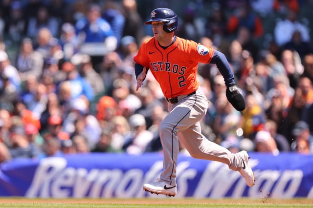 CHICAGO, ILLINOIS - APRIL 25: Alex Bregman #2 of the Houston Astros advances to second on a passed ball against the Chicago Cubs during the first inning at Wrigley Field on April 25, 2024 in Chicago, Illinois.